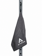 ATHRON gym towel clipped to a squat rack by its magnetic strap