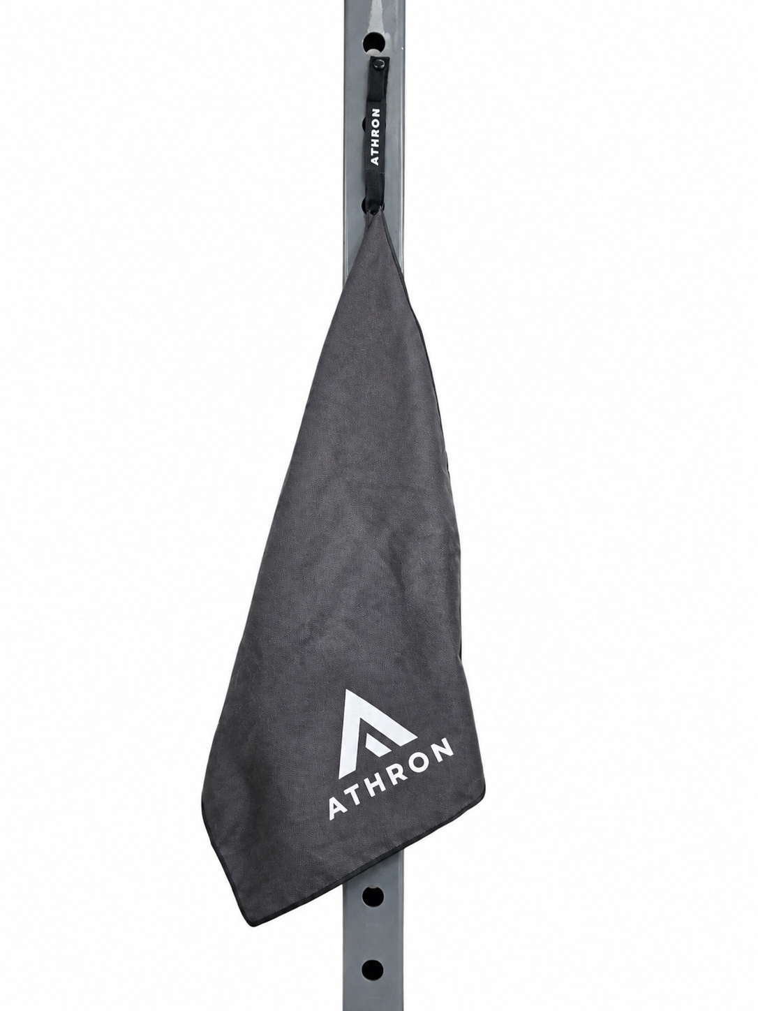 ATHRON gym towel clipped to a squat rack by its magnetic strap