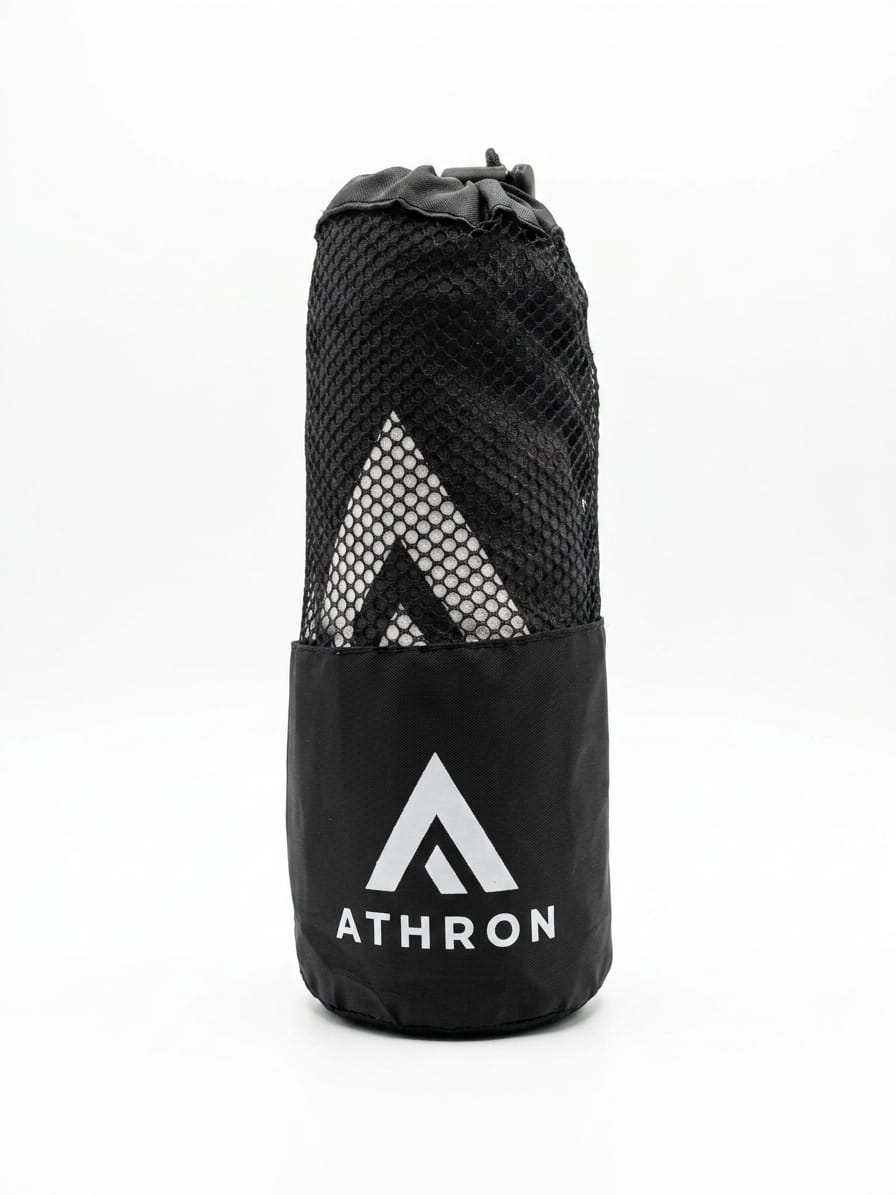 ATHRON gym towel folded into its branded mesh carry pouch