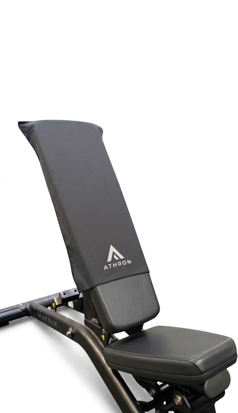 ATHRON gym towel draped over a Matrix weight bench