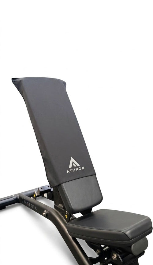 ATHRON gym towel draped over a Matrix weight bench