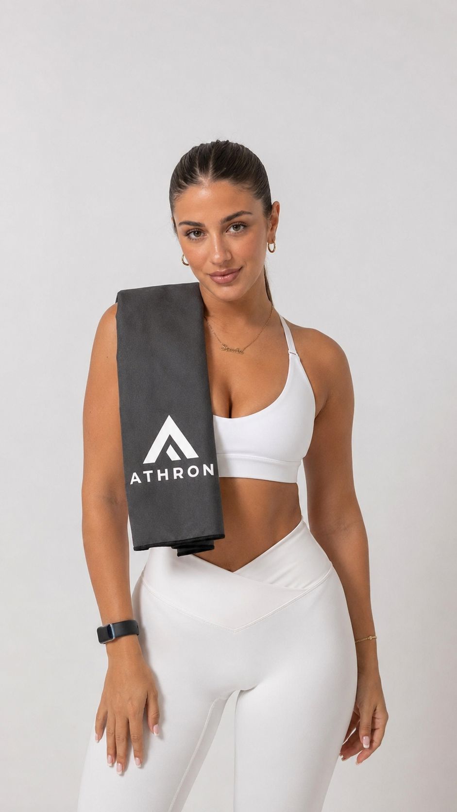 ATHRON magnetic gym towel in dark grey microfibre suede, carried over the shoulder
