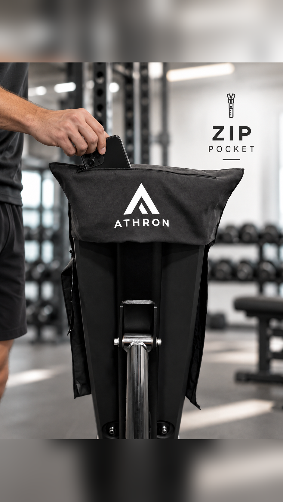 ATHRON magnetic gym towel with a zip pocket, shown with a hand placing a phone inside